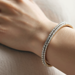 **

*   **Prompt:** Close-up photo of a slender wrist adorned with a delicate white gold bracelet. Focus on the subtle sparkle and the bracelet's fine chain. Soft, diffused lighting to emphasize elegance. Background: blurred neutral tones.

**